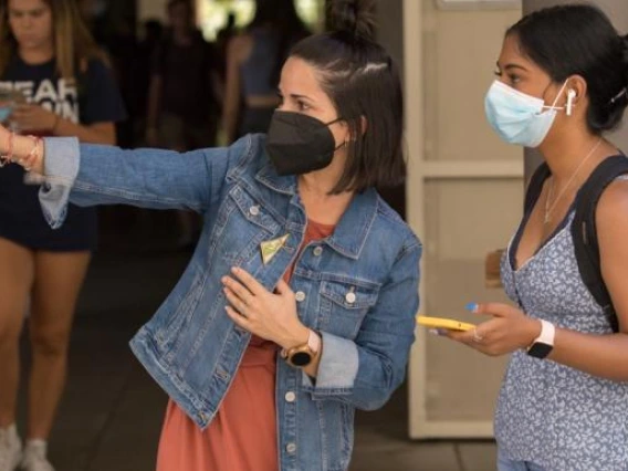 woman directing student