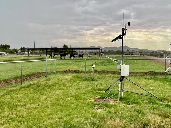 weather sensors standing on towers in a small field