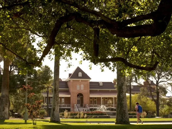 a person walking in front of old main