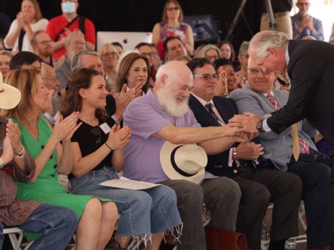 President Robbins shakes Andrew Weil&#039;s hand